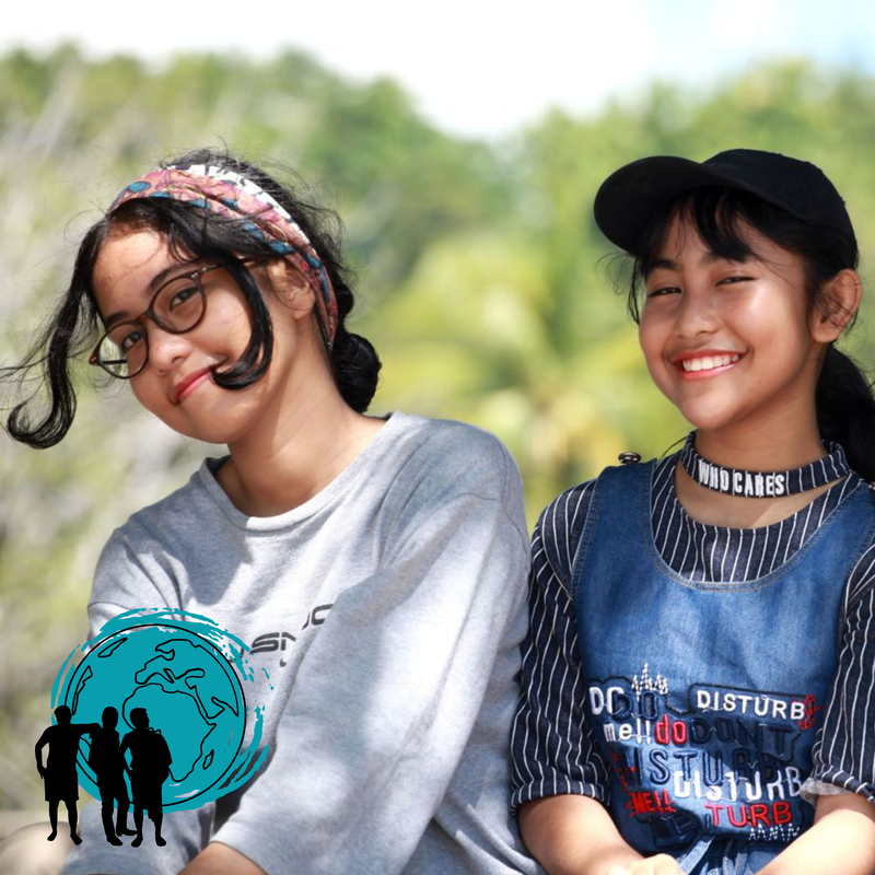 A color image of two girls hanging out together with an icon that represents belonging. The image provides and introduction to Cultured Kids focus on belonging in the Art & Storytelling Book Club Program.  